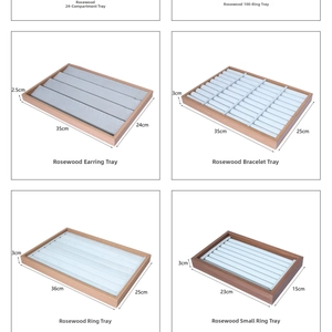 Detailed view of luxury rosewood jewelry display trays with soft grey velvet lining