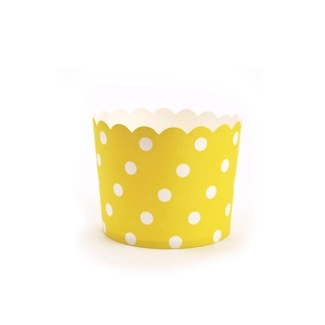 Close-up of yellow polka dot paper muffin cups with scalloped edges for baking