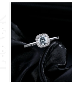 Macro shot of 50-carat grey moissanite ring with halo setting on black leather