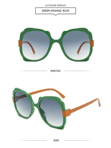 Detail view of butterfly frame sunglasses with green front, orange temples and blue gradient lenses