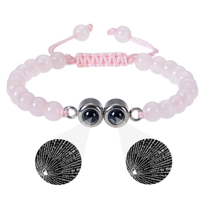 Detail of pink stone beaded bracelet featuring multi-language I Love You projection pendant