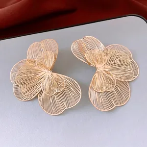 Golden hollow petal statement earrings with fine textured metallic brushed finish