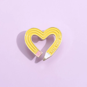 Cute heart shaped pencil enamel pin with Make More Art slogan on purple background