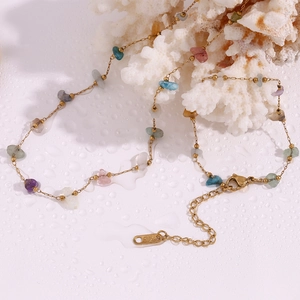 Detail of 18K gold-plated stainless steel chain with colorful natural stone fragments