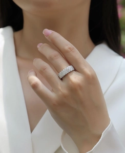 Close-up of model wearing a luxury 925 sterling silver triple row moissanite eternity ring