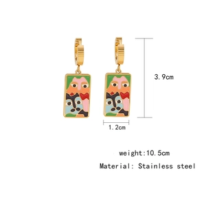 Detail of stainless steel hook earrings with abstract face design and dimensions