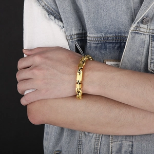 Mens gold double-ring O-chain bracelet with buckle on model wearing denim