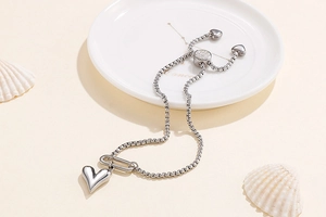 Detailed shot of silver heart charm bracelet with adjustable sliding toggle clasp