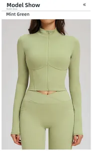 Front view of dusty green slim-fit yoga jacket with zipper and high-waist V-cut leggings