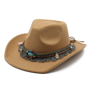 Detail of khaki felt cowboy hat featuring turquoise bead band and tassels