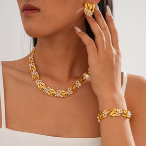Detail of vintage gold leaf jewelry set with pearls and rhinestones on a female model