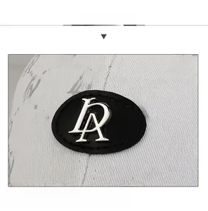 Macro shot of fashion baseball cap with LA monogram print and metal logo detail