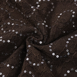 Close-up of deep brown lace fabric with shimmering silver sequins and intricate mesh texture