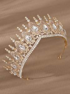 Detail of luxury baroque bridal crown with clear crystals on brown silk fabric