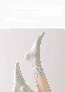 Close-up of breathable mesh texture on silk crew socks featuring stylish ruffled cuffs