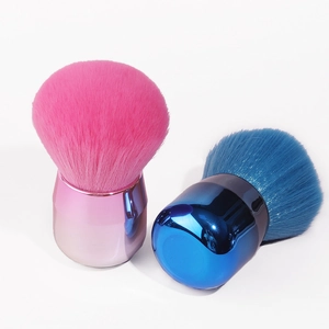 Detailed view of pink and blue mushroom powder brushes with metallic handles