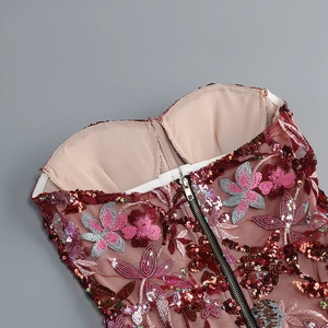 Close-up of floral embroidery and sequins on the bodice of a burgundy evening gown