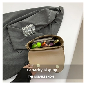 Macro shot showing internal storage capacity for cosmetics and smartphone in saddle bag