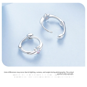 Close-up of S925 sterling silver star earring with pink zircon and hallmark stamp