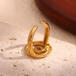 Detail shot of a 18K gold plated stainless steel spiral open ring on stone base