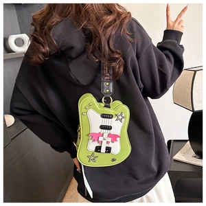 Rear view of model wearing a guitar-shaped crossbody bag with star rivets and wide strap