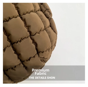 Macro detail of dark brown quilted puffer fabric with square stitching texture