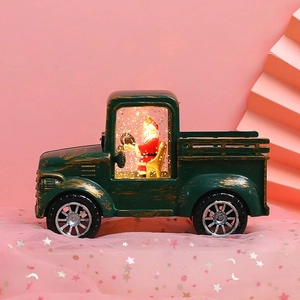 Macro view of vintage green Christmas truck ornament with Santa Claus and warm LED light