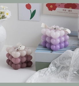 Macro view of gradient heart cube scented candles with elegant For You silk ribbon bow