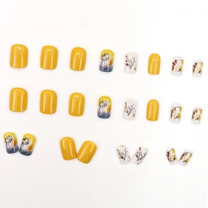 Press-on nail set featuring yellow and pearl white colors with romantic leaf patterns