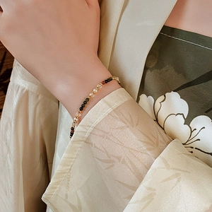 Detail of 18K gold-plated beaded bracelet with colorful pearls and crystals on wrist