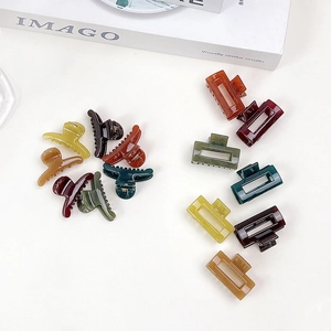Close-up of assorted mini matte and jelly textured hair clips in various colors