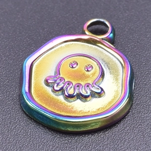 Macro detail of rainbow stainless steel octopus pendant with 18k gold plating finish