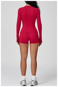 Back view of slim fit long sleeve yoga top and high waist sports shorts in dark red