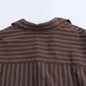 Detail of brown striped shirt yoke showing vertical and horizontal line contrast