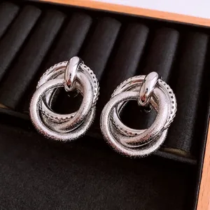 Irregular silver earrings with nested smooth, matte, and zircon-encrusted rings