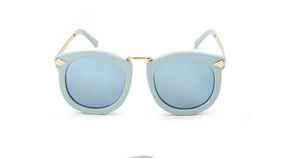 Detail of vintage cat-eye sunglasses with light blue frames and gold metal temples