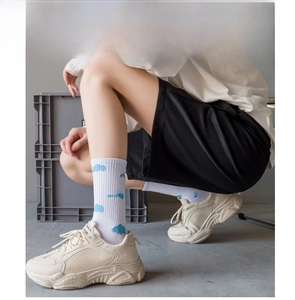 Fashionable white mid-calf socks featuring cute blue cloud patterns, ideal for daily wear.
