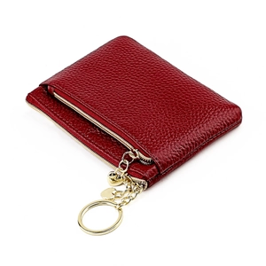 Detail of red genuine leather coin purse with golden metal zipper and keychain chain