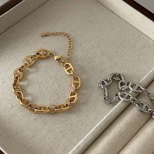Detail of adjustable lobster clasp and extension chain on 18k gold link bracelets