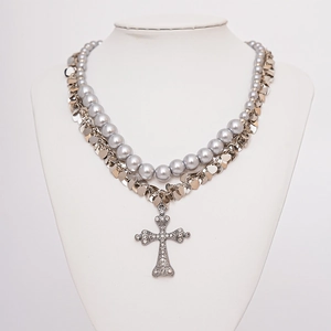 Detail of double-layer necklace with grey faux pearls, silver heart sequins and cross pendant