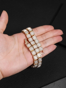 Close-up of a 13mm gold cuban link necklace with sparkling crystals in a hip-hop style