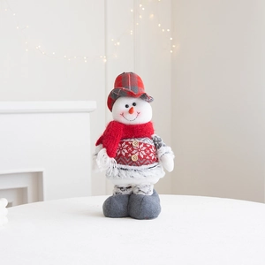 Detail of Christmas snowman plush doll with red scarf and snowflake knit pattern
