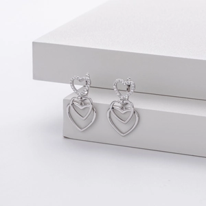 Macro shot of S925 sterling silver heart earrings featuring white zircon pavé details