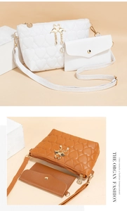 Detail of heart-quilted crossbody bags with golden swan closure on geometric blocks