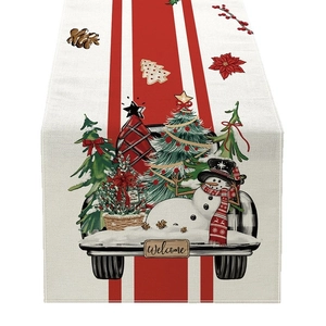 Christmas table runner with red truck, snowman and tree design on white fabric