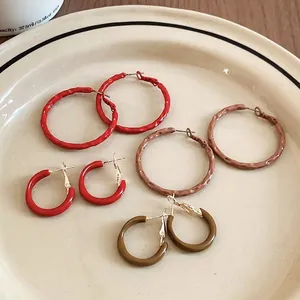 Set of four geometric hoop earrings in red, caramel, olive green and terracotta colors