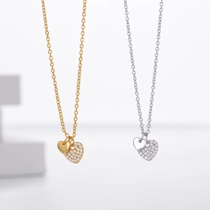 Macro detail of overlapping double heart pendants with cubic zirconia inlay on a thin chain