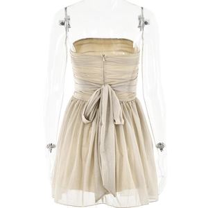Rear view of beige off-shoulder mini dress with mesh splicing and large back bow detail