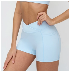 Detail of high-waist criss-cross waistband on sky blue yoga shorts with flatlock seams