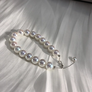 Elegant S925 sterling silver pearl bracelet with aurora luster on white silk background